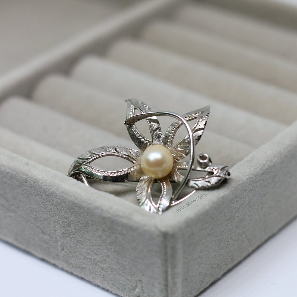Elegant floral pin with a classic Akoya pearl centerpiece